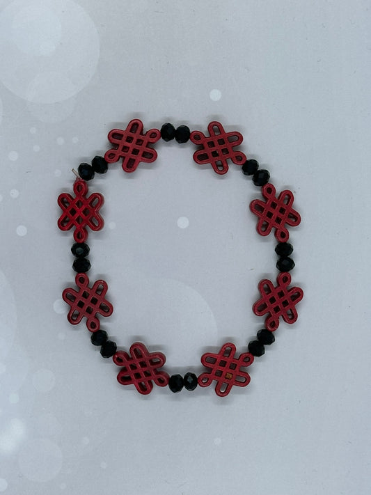Red Endless Knot Bracelet with Faceted Black Beads – Handmade Symbolic Jewelry